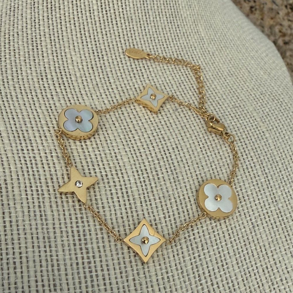 Gold tone stainless steel Bracelet with White Floral Charms